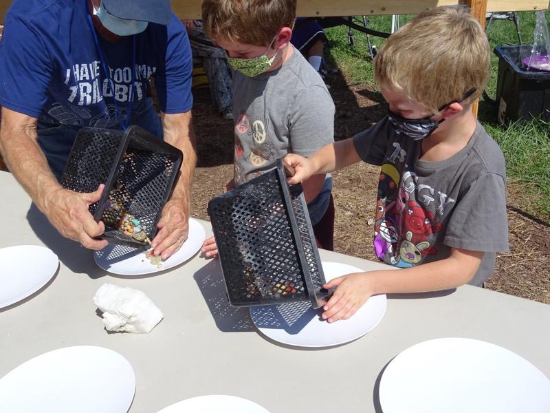Young prospectors checking out their finds from the sluice